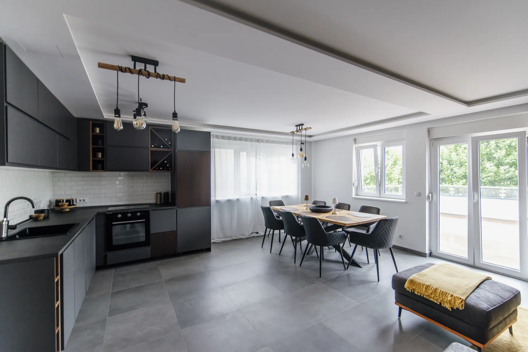 A bright, modern kitchen and dining area with natural light